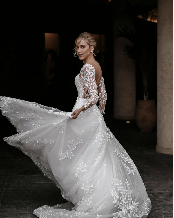 Model wearing a white Beloved by Casablanca gown